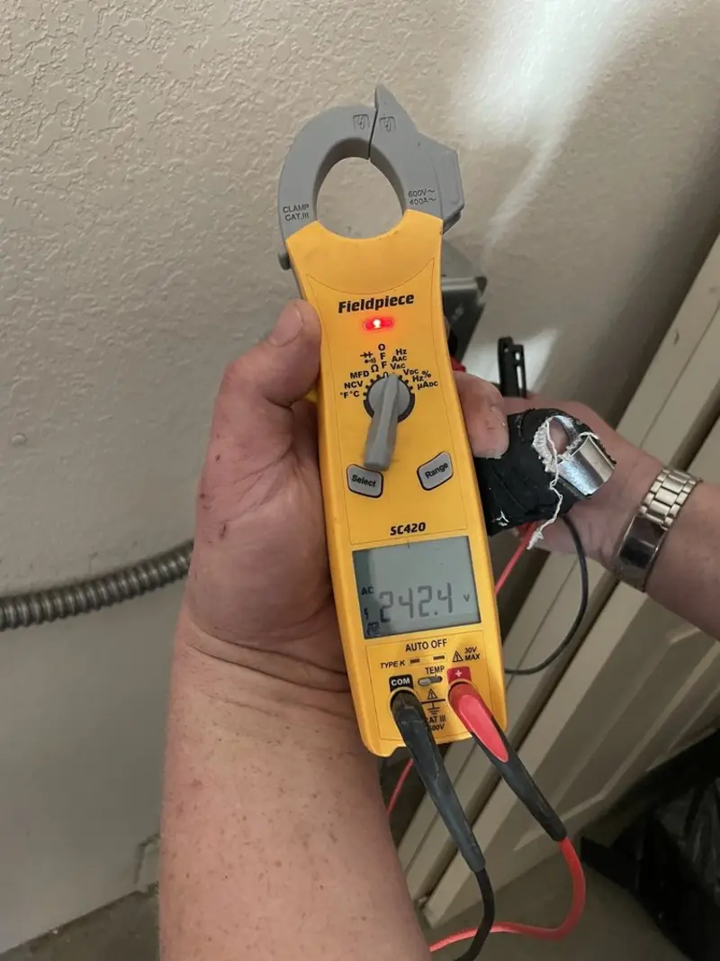 Voltage testing with clamp meter during Ceiling Fan Installation in Pike Creek